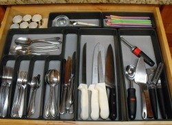 Organized kitchen utensil drawer storage tray.